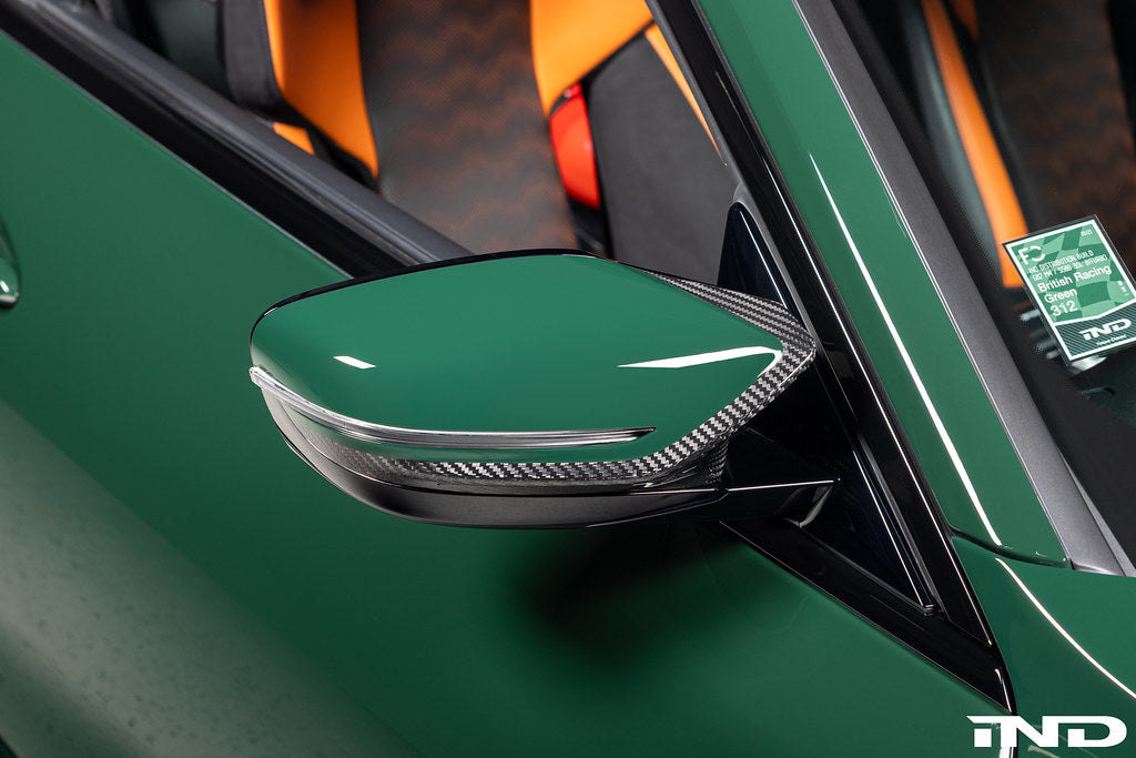Alpha N G8X M2, M3, M4 carbon mirror cap set for exterior, showing sleek black finish on side mirrors.