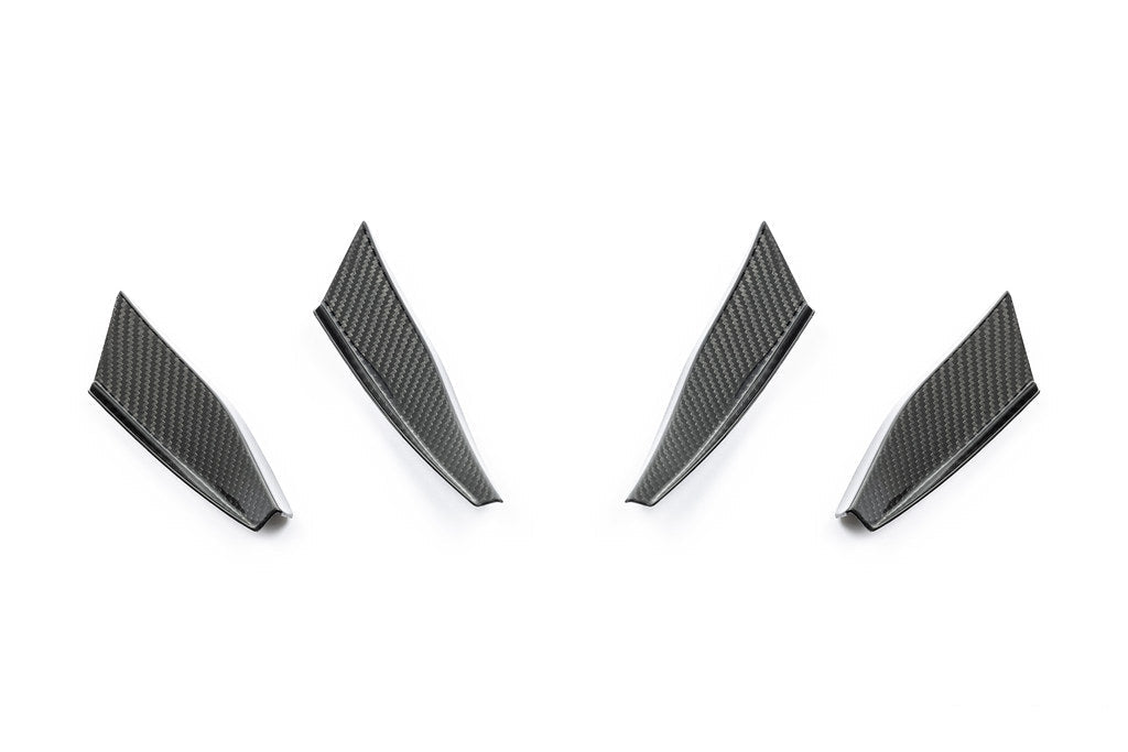 Alpha N G87 M2 carbon bumper canard set installed on white background, showcasing aerodynamic exterior car enhancements.
