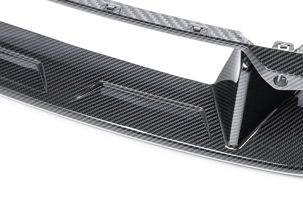 Alpha-N G87 M2 carbon front center bumper trim installed on a white background, showcasing a sleek exterior car part.