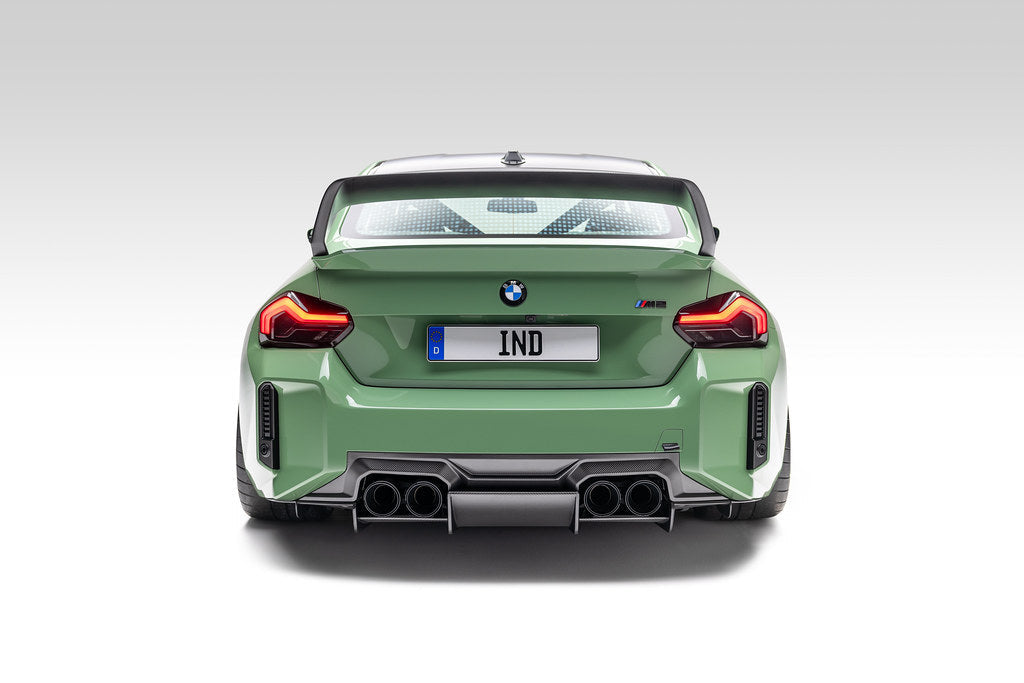 Alpha N G87 M2 carbon rear underbody floor kit installed on a vehicle, showcasing sleek carbon fiber exterior automotive upgrade.