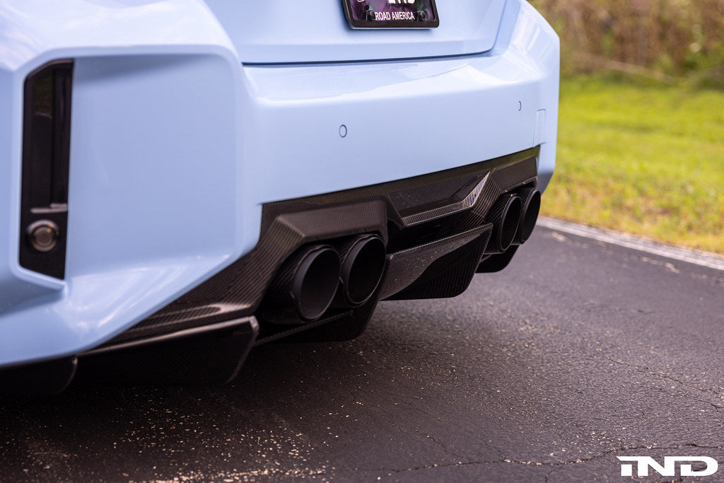 Alpha N G87 M2 carbon rear underbody floor kit installed on a BMW M2, showing sleek black carbon fiber exterior components.