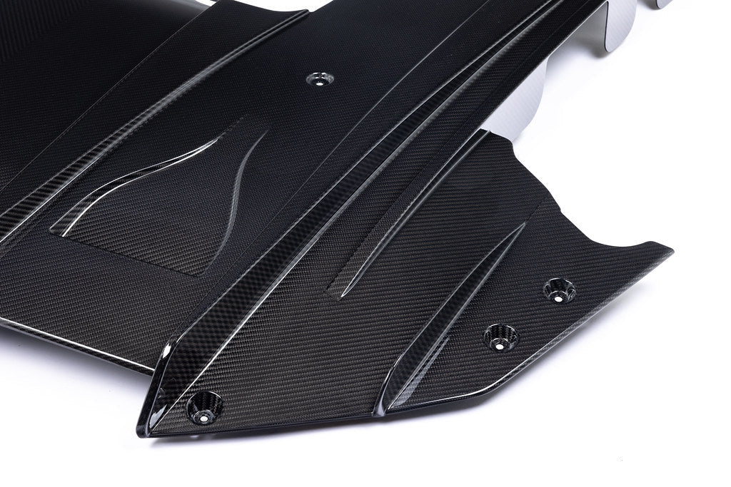 Alpha N G87 M2 carbon rear underbody floor kit installed on a car, shown against a white background.
