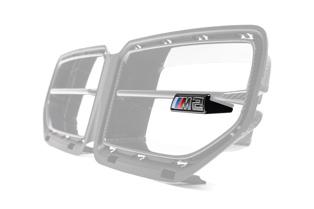 Alpha-N G87 M2 LCI front grille emblem retainer with BMW M2 badge installed on exterior of vehicle.