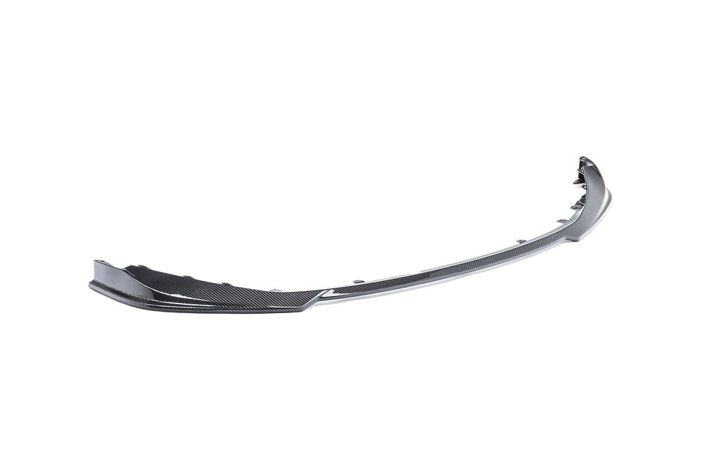 Alpha N G8X M3 M4 carbon front spoiler installed on a vehicle, showcasing its aerodynamic design on a white background.
