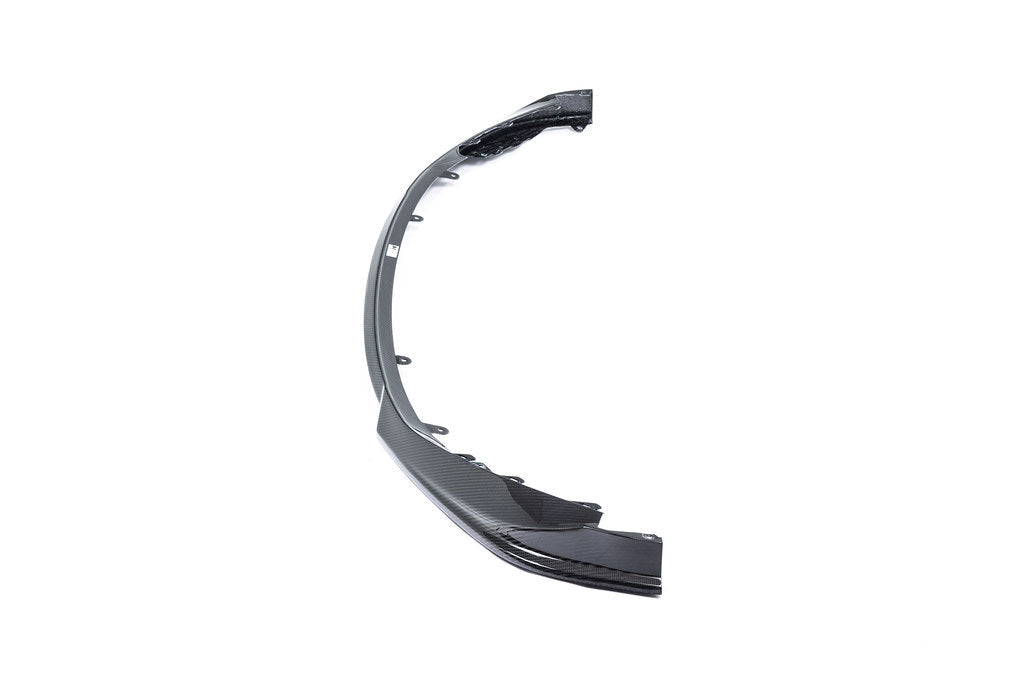 Alpha N G8X M3 M4 carbon front spoiler mounted on a white background, showcasing its sleek exterior design and lightweight construction.
