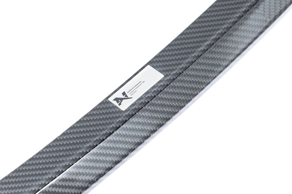 Alpha N G8X M3 M4 carbon front spoiler installed on white background, showcasing aerodynamic exterior car enhancement.