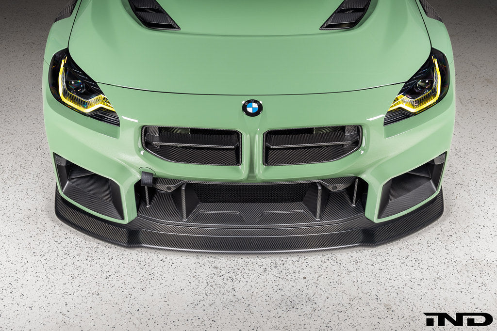Alpha N G87 M2 Carbon Corse front splitter installed, matte clear exterior car accessory enhancing aerodynamics and style.