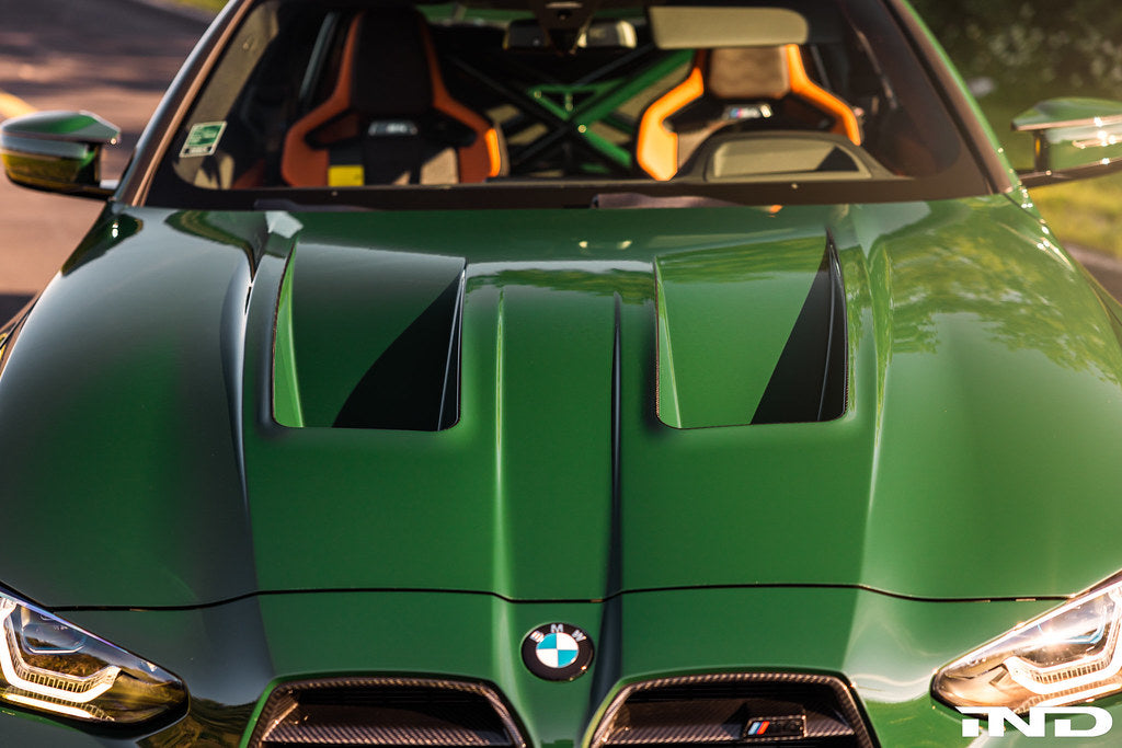 Alpha N Alpha-N G8X M3/M4 carbon vented hood installed on a vehicle, showcasing lightweight, aerodynamic exterior design.