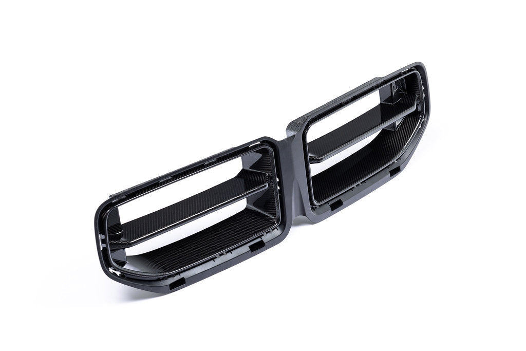 Alpha N G87 M2 Carbon front grille mounted on a BMW M2, showcasing a sleek, textured carbon fiber exterior upgrade.