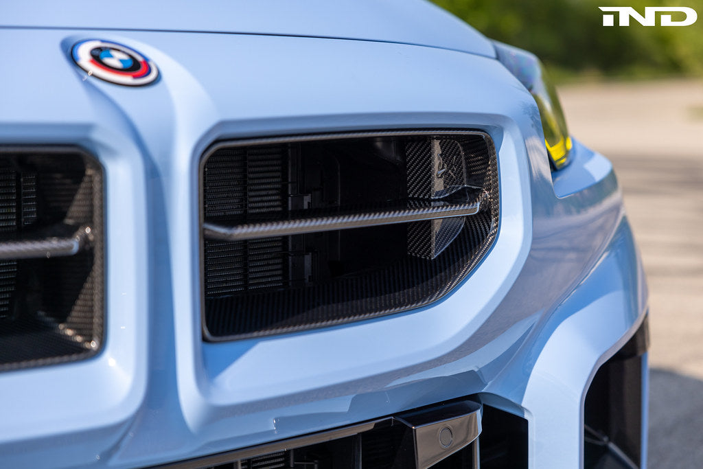 Alpha N G87 M2 carbon front grille for BMW, exterior view showing sleek black carbon fiber design and precise fit.