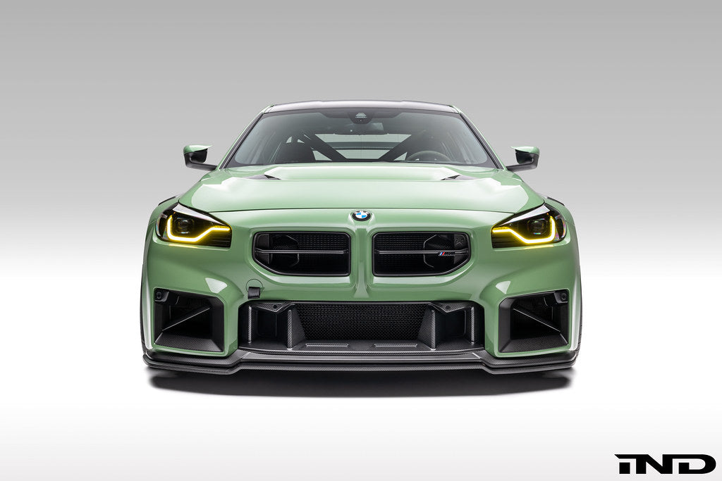 Alpha N G87 M2 carbon front grille for BMW, exterior view showing sleek black mesh design and aerated construction.