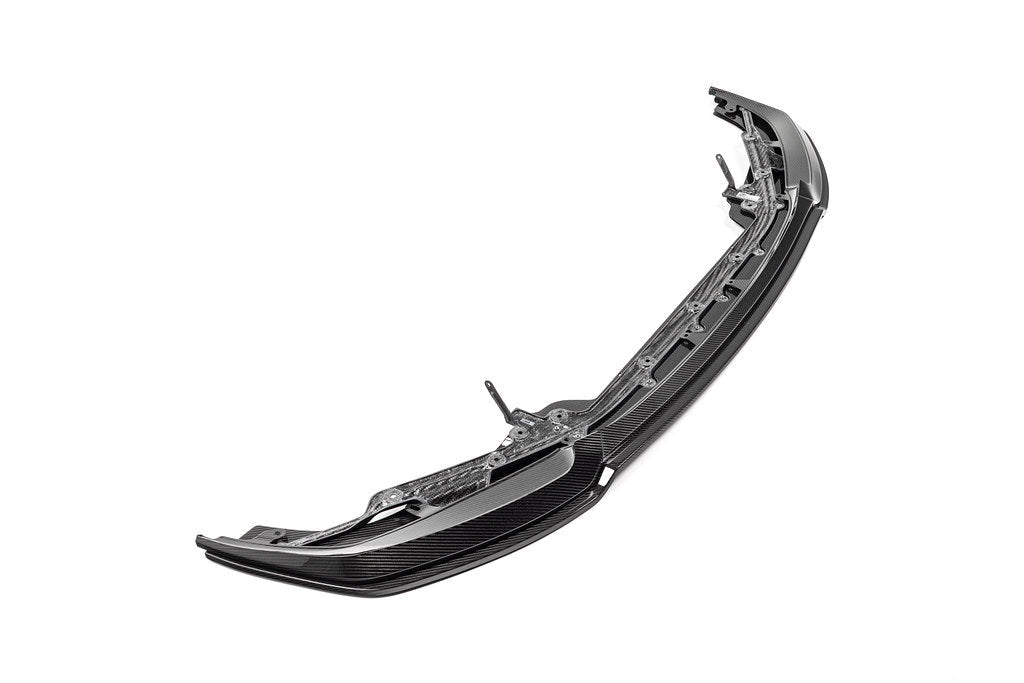 Alpha N G87 M2 carbon adjustable front lip, Class 3, mounted on a white background, showcasing its sleek exterior design.