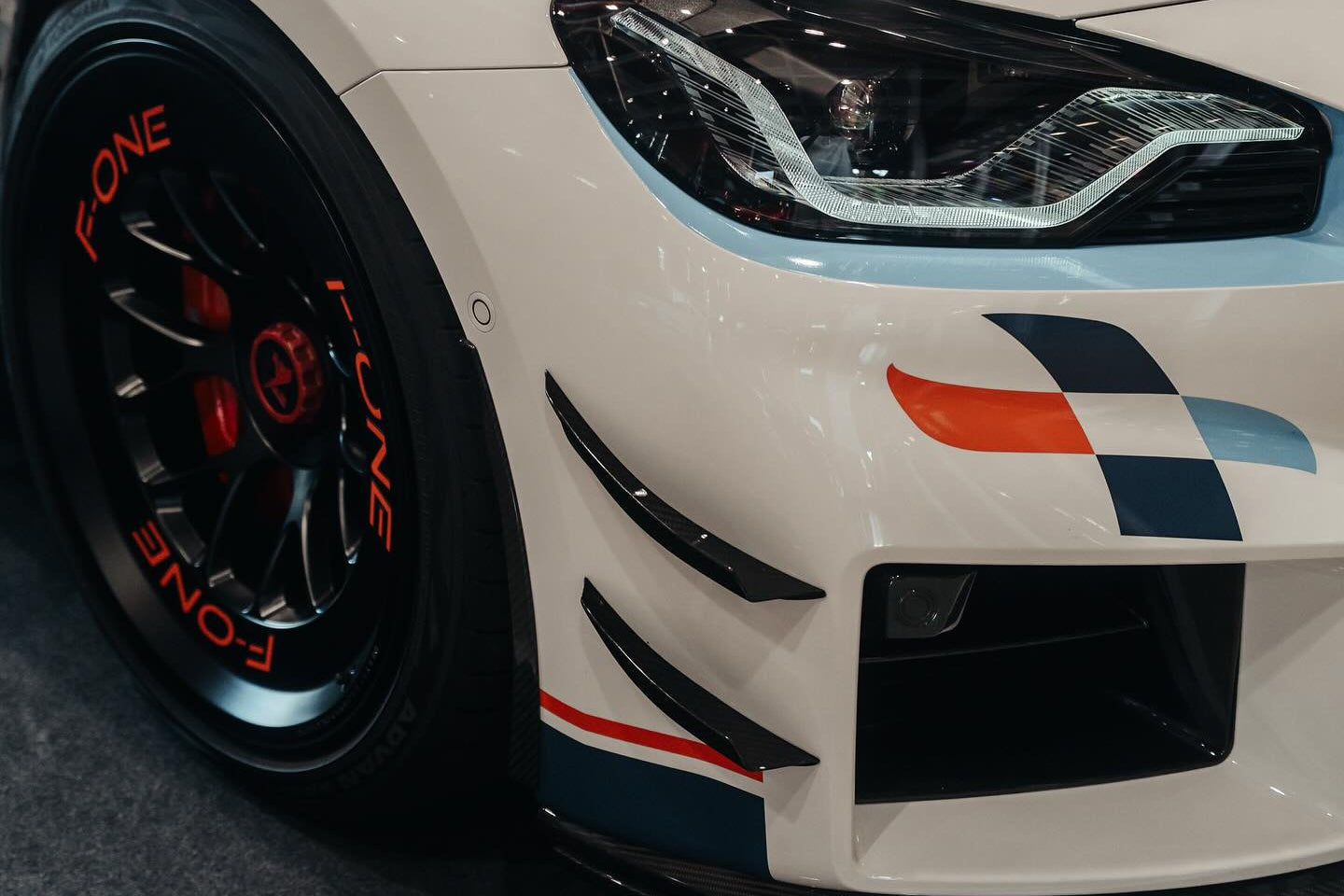 Alpha-N carbon bumper canard set installed on BMW G87 M2 front bumper