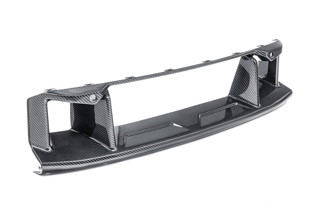 Alpha-N G87 M2 carbon front center bumper trim mounted on a vehicle, showcasing sleek white finish on exterior car part.