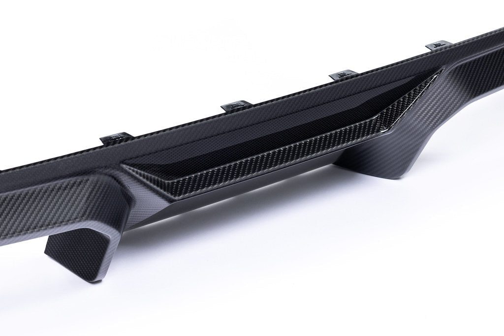 Alpha N G87 M2 carbon rear diffuser installed on car, showcasing sleek exterior design on a white background.