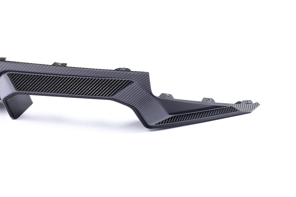 Alpha N G87 M2 carbon rear diffuser mounted on a white background, showcasing its aerodynamic design and high-quality carbon fiber finish.