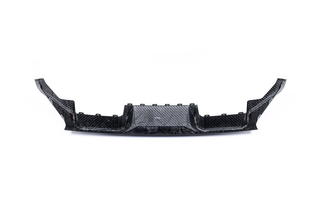 Alpha N G87 M2 carbon rear diffuser installed on a white background, showcasing its aerodynamic design and sleek carbon fiber finish.