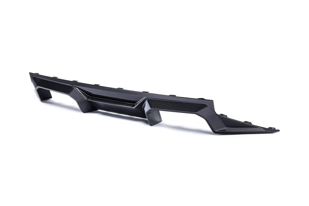 Alpha N G87 M2 carbon rear diffuser installed on a car, showcasing its sleek white finish and aerodynamic design.