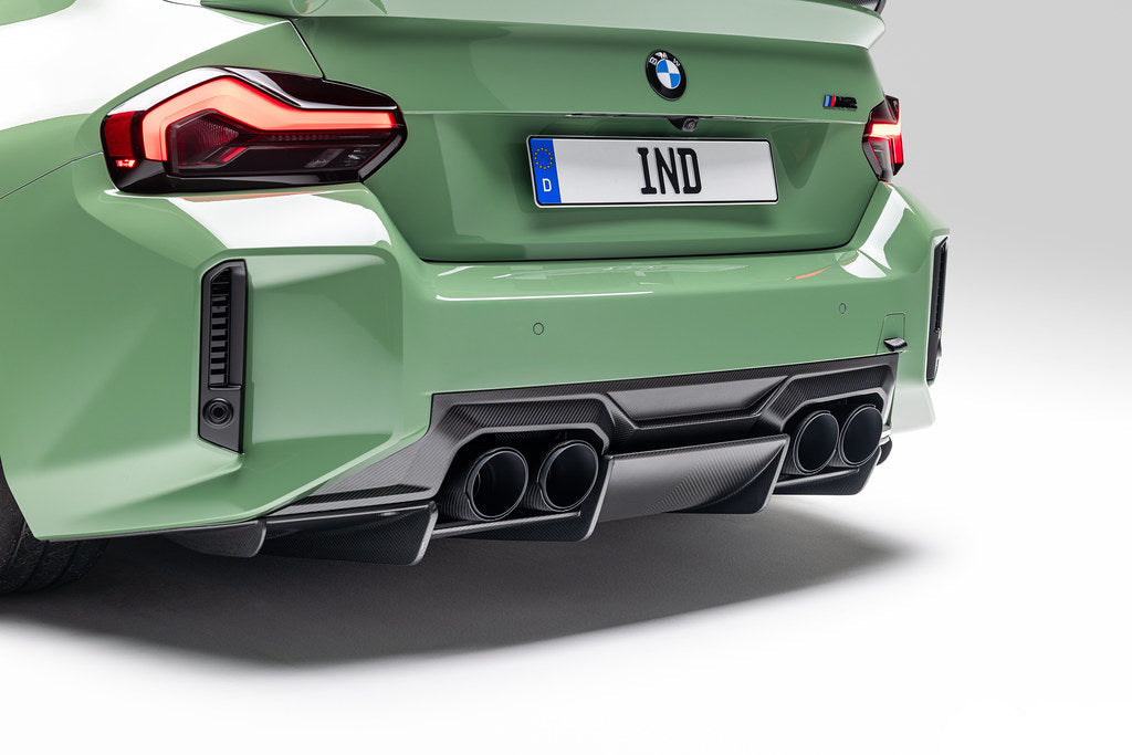 Alpha N G87 M2 carbon rear underbody floor kit installed on a BMW M2, showcasing the sleek carbon fiber exterior modification.