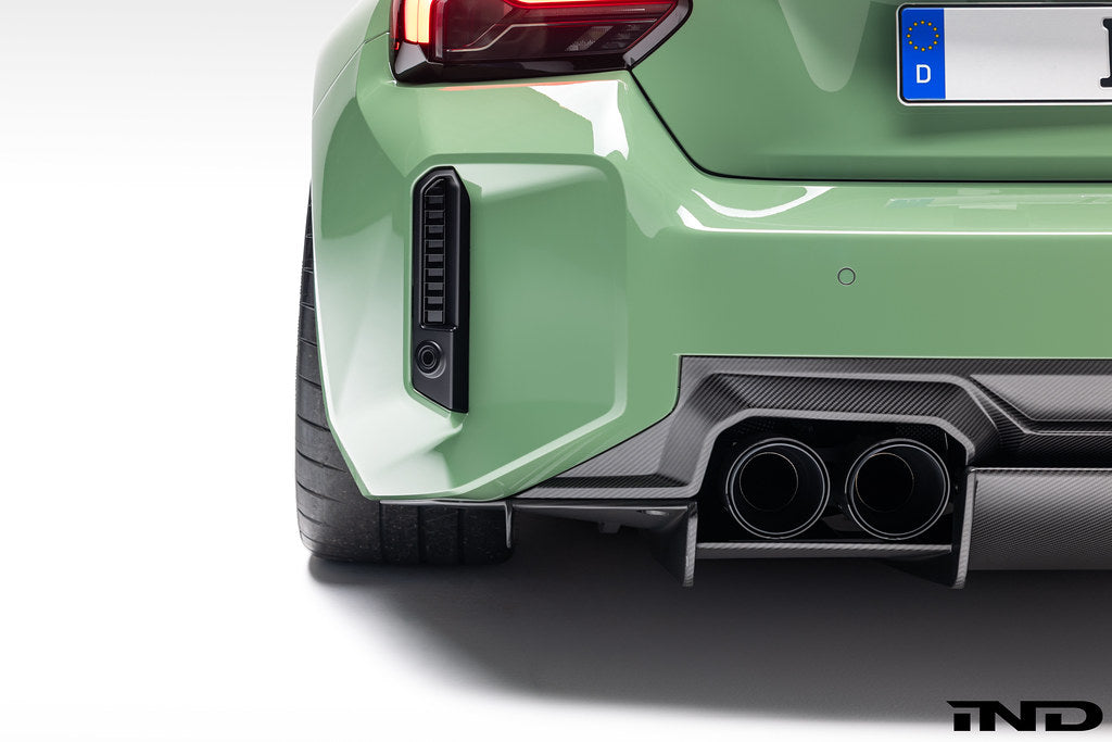 Alpha N G87 M2 carbon rear underbody floor kit installed on a BMW M2, showcasing sleek carbon fiber exterior components.