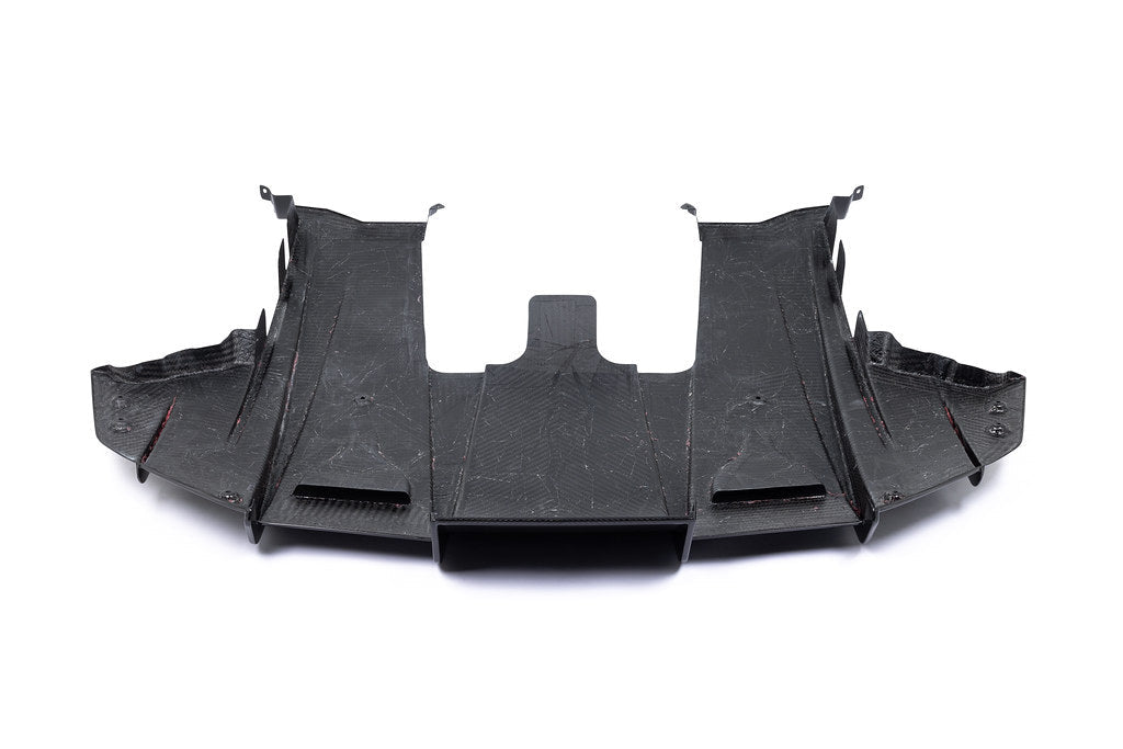 White Alpha N G87 M2 carbon rear underbody floor kit installed on a car, showing the sleek aerodynamic design against a plain background.