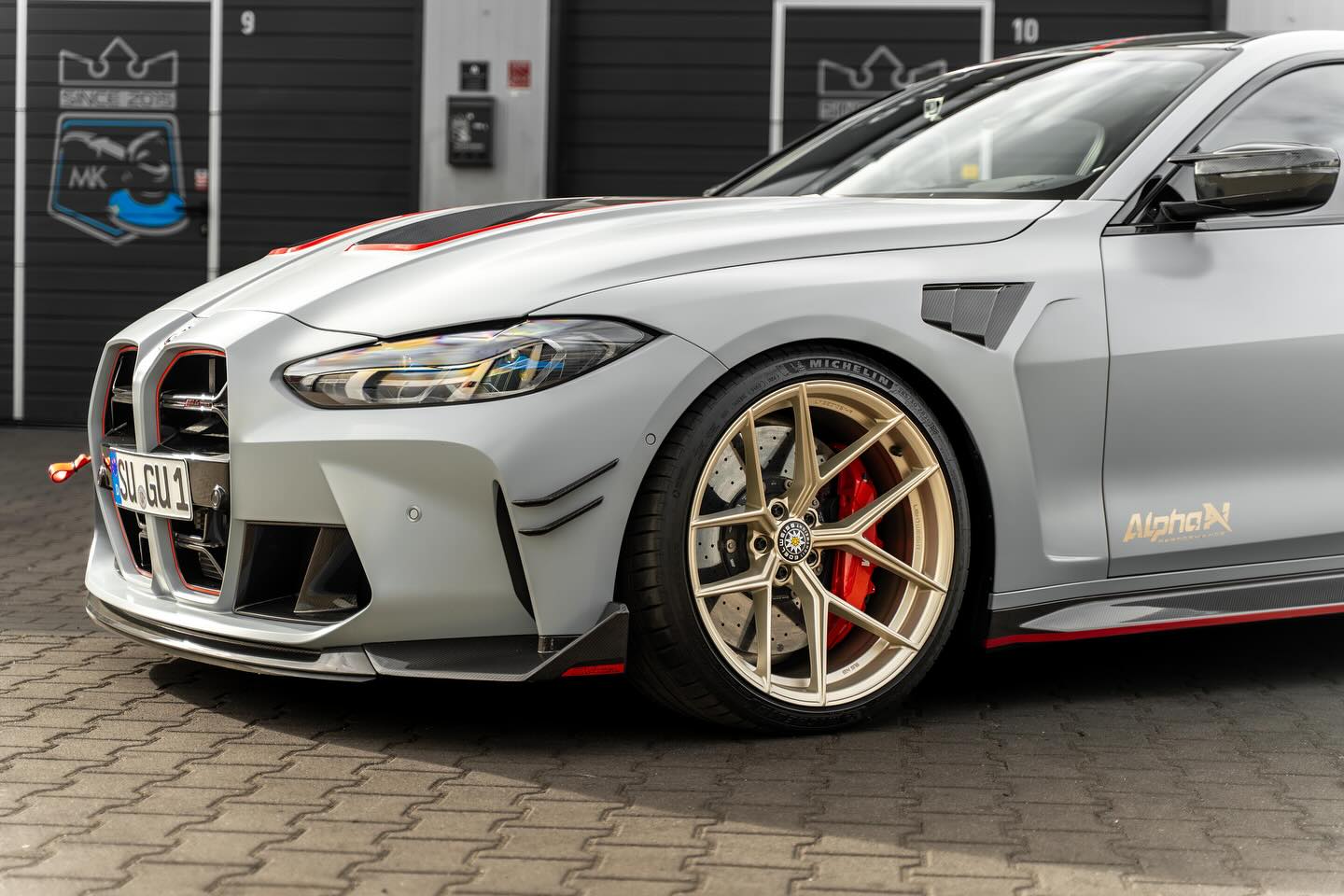 Alpha N G8X M3 M4 carbon vented front fenders installed on BMW G8X series, showcasing lightweight exterior upgrade.