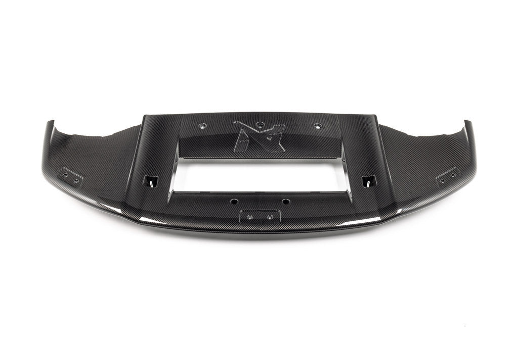 Alpha-N G87 M2 carbon Corse front splitter installed on vehicle, showcasing sleek white exterior with detailed aerodynamic design.