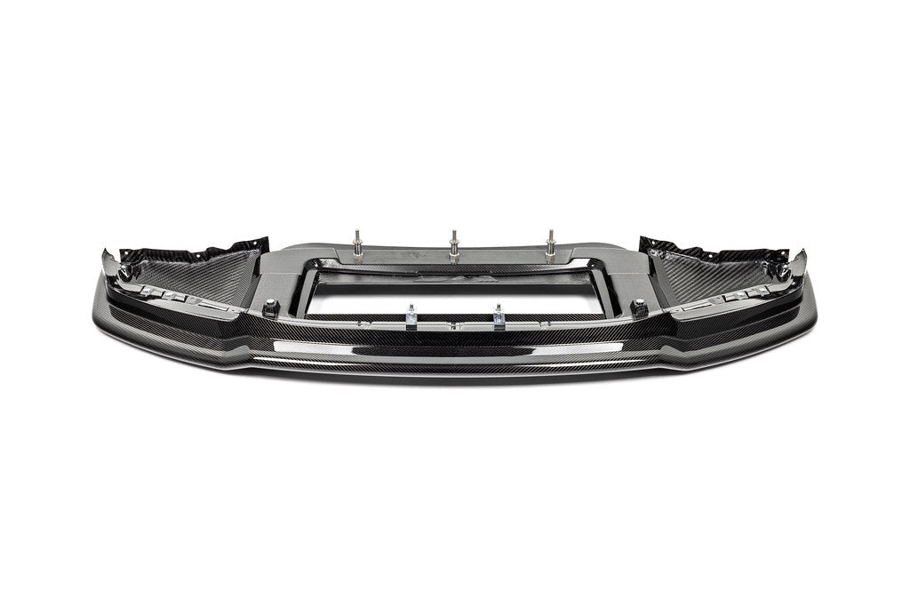Alpha N G87 M2 Carbon Corse front splitter shown on a white background, highlighting its sleek carbon fiber exterior design.