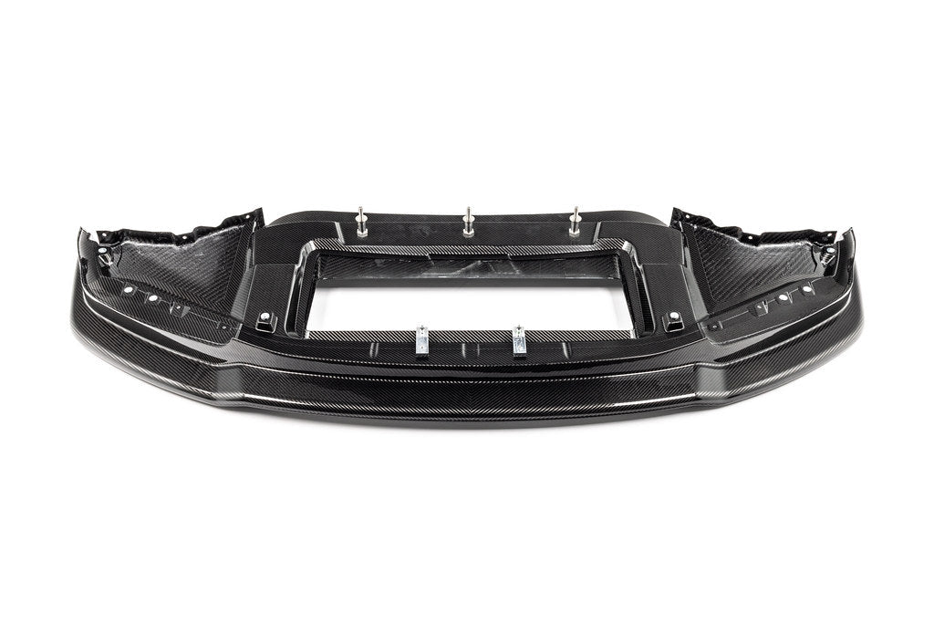 Alpha-N G87 M2 Carbon Corse front splitter mounted on a car, showcasing its aerodynamic design on a white background.