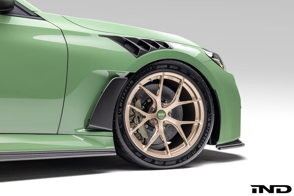 Alpha N G87 M2 carbon vented front fender set with V4 blades installed on a vehicle, showcasing lightweight, high-performance exterior accessories.