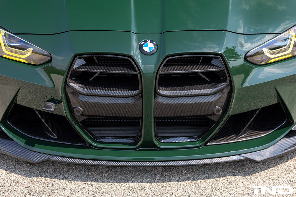 Alpha N G8X M3 M4 carbon front grille installed on vehicle, showcasing sleek exterior design and high-quality craftsmanship.