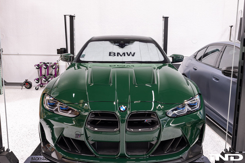 Alpha N G8X M3 M4 carbon front grille installed on vehicle, showcasing custom paint finish and sleek exterior design.